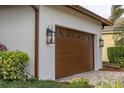 Brown garage door with decorative windows and black lanterns at 6720 The Masters Ave, Lakewood Ranch, FL 34202