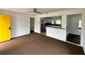 Bright living room with yellow door and kitchen at 732 Riverside Dr, Tarpon Springs, FL 34689