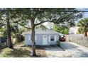 Gray house with a white trim, green lawn, and a driveway at 510 S Disston Ave, Tarpon Springs, FL 34689