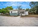 Front view of a small house with a gravel driveway at 2216 52Nd N Ave, St Petersburg, FL 33714