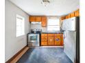 Simple kitchen with wood cabinets, stainless steel appliances, and tile floor at 2216 52Nd N Ave, St Petersburg, FL 33714