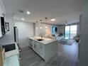 Modern kitchen with white cabinets, quartz counters, and island at 750 N Tamiami Trl # 814, Sarasota, FL 34236