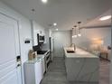 Modern white kitchen with stainless steel appliances at 750 N Tamiami Trl # 814, Sarasota, FL 34236