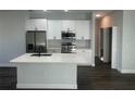 Modern kitchen with white shaker cabinets, stainless steel appliances, and a large island at 1401 Newton St, Port Charlotte, FL 33952