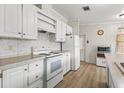 White kitchen with ample cabinetry and an island at 3105 Beaver Creek Dr, Wesley Chapel, FL 33543