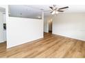 Living room featuring light walls, wood-look floors, and a ceiling fan at 4215 Pecos Dr, New Port Richey, FL 34653