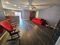 Living room with dark hardwood floors and red couch at 2022 Peaceful Palm St, Ruskin, FL 33570