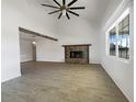 Bright living room featuring a stone fireplace and hardwood floors at 4000 Barbary Ln, North Port, FL 34287