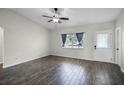 Bright living room with gray tile floors and a ceiling fan at 13910 Fullerton Dr, Tampa, FL 33625