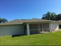 A spacious screened-in lanai and a lush green lawn enhance this home's backyard at 4666 Laramie Cir, North Port, FL 34286