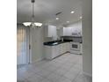 Bright kitchen with white cabinets and tile floor at 4666 Laramie Cir, North Port, FL 34286