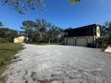 Property with a house, detached garage, and a gravel driveway at 7027 Hawkins Rd, Sarasota, FL 34241