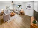 Bright living room with light wood floors and comfy furniture at 9640 Mark Twain Ln, Port Richey, FL 34668