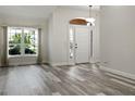 Spacious living room with wood-look floors and neutral colors at 2321 E Del Webb Blvd, Sun City Center, FL 33573