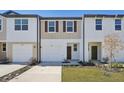 Two-story townhouse with attached garage and landscaping at 6184 Pina Colada St, Zephyrhills, FL 33542