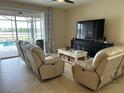 Relaxing living room with lake view and comfortable seating at 13642 Newport Shores Dr, Hudson, FL 34669