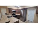 Modern kitchen with stainless steel appliances and tile countertops at 231 W Cornelius Cir, Sarasota, FL 34232