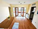 Cozy living room with wood floors and French doors leading to an outdoor area at 802 Gateway Ln, Tampa, FL 33613