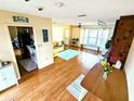 Open-concept living area featuring wood floors, a sofa, and a view into the kitchen at 802 Gateway Ln, Tampa, FL 33613