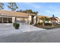 Front view of home showcasing garage and driveway at 18004 Tarrington Pl, Hudson, FL 34667
