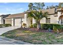 Side view of home highlighting landscaping and garage at 18004 Tarrington Pl, Hudson, FL 34667