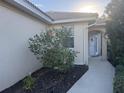 Home's entrance with walkway, landscaping, and white door at 3375 Osprey Ln, Port Charlotte, FL 33953