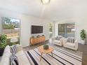 Cozy staged living room with stylish furniture, rug, and a view of the backyard at 14315 Knoll Ridge Dr, Tampa, FL 33625