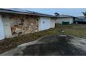 Attached garage with stone exterior and double doors at 23102 Maclellan Ave, Port Charlotte, FL 33980