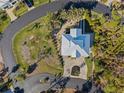 Bird's eye view of a single-Gathering home with a metal roof and driveway at 7092 Baypine Ln, Englewood, FL 34224