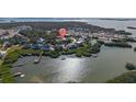 Property located on a waterway with nearby houses and boats at 7092 Baypine Ln, Englewood, FL 34224