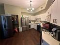 Kitchen features stainless steel appliances and wood flooring at 1702 Arabian Ln, Palm Harbor, FL 34685