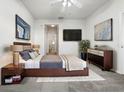 Spacious bedroom with a large bed, dresser, and artwork at 3473 Parkridge Cir # 17-101, Sarasota, FL 34243