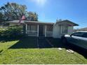 White single-story house with front porch and American flag at 2205 Mcgee Rd, Plant City, FL 33565