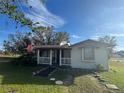 Single story home with front porch and American flag at 2205 Mcgee Rd, Plant City, FL 33565