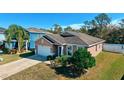One-story house with a white garage door and blue front door, next to other houses at 2729 Walden Woods Dr, Plant City, FL 33566