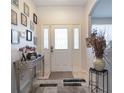 Bright and airy entryway with tile floors and decorative accents at 4126 Cobbler Ln, North Port, FL 34286