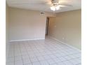 Open living room area featuring tile flooring and neutral wall paint at 4885 Rilma Ave # 130, Sarasota, FL 34234