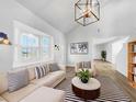 Bright living room featuring a sectional sofa, coffee table, and stylish decor at 7326 Shepherd St, Sarasota, FL 34243