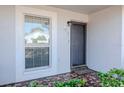 Front entry with dark door and tiled flooring at 7710 Danube Dr # A, Hudson, FL 34667