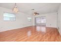 Bright living room with laminate flooring and sliding doors to a screened porch at 7710 Danube Dr # A, Hudson, FL 34667