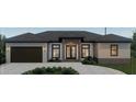 Modern home exterior with a 2-car garage and landscaped front yard at 1405 Point Of Pines, Englewood, FL 34223