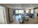 Open living room and kitchen with tile floors and neutral color palette at 1835 Scarlett Ave, North Port, FL 34289