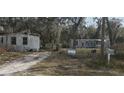 Two mobile homes on a lot with a For Sale sign at 10920-10928 Malati St, New Port Richey, FL 34654