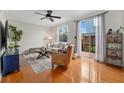 Living room with hardwood floors, off-white couch, and access to backyard at 2607 W Cleveland St # B, Tampa, FL 33609