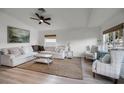 Spacious living room with light beige sectional sofa and light wood floors at 30350 Grymes Dr, Wesley Chapel, FL 33545