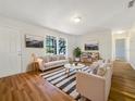 Bright living room featuring light beige walls, wood flooring, and comfy sofas at 5220 Lords Ave, Sarasota, FL 34231
