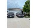 The home's exterior features a two-car garage and landscaping in the front yard at 7111 Amelia Cove Ct, Sun City Center, FL 33573