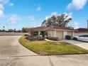 Charming home featuring a red tile roof, well-maintained landscaping, and an attached two-car garage at 18315 Aintree Ct, Tampa, FL 33647