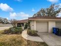 Charming home featuring a red tile roof, well-maintained landscaping, and an attached one-car garage at 18315 Aintree Ct, Tampa, FL 33647