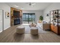 Inviting living room boasts a stone fireplace, neutral color palette, and sliding doors to the screened in lanai at 18315 Aintree Ct, Tampa, FL 33647